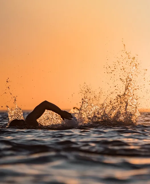 Swimmer in the ocean at sunrise off Newcastle
